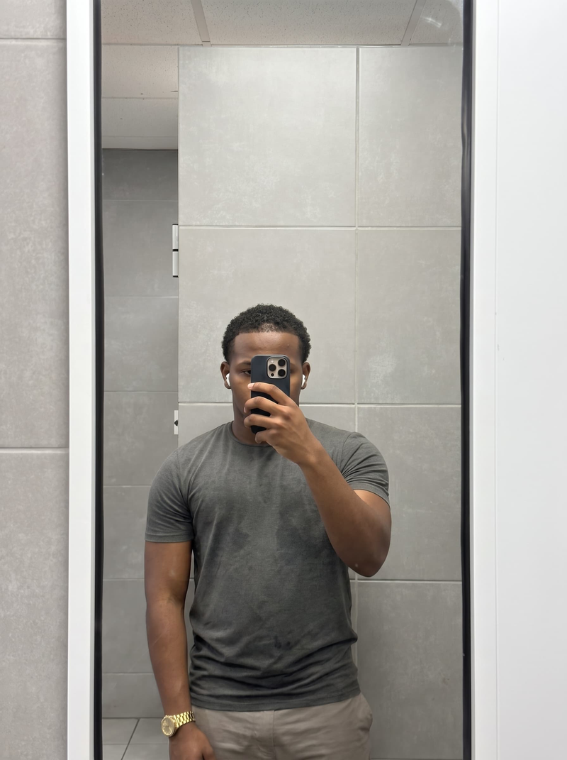 Man who is 5'5" wearing a size M PrimeCut tee in heather grey